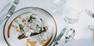On a table there is a plate with South Tyrolean specialties, the table is set.