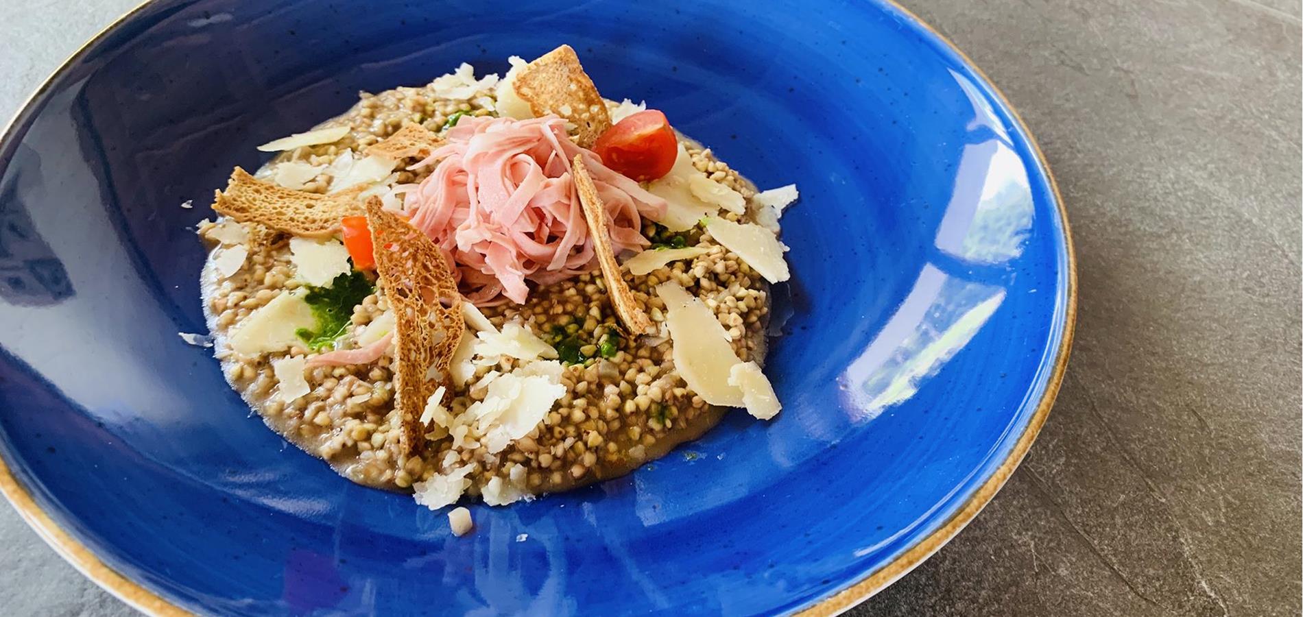 Buckwheat Risotto with garden cress pesto, mortadella, pecorino shavings and “Paarlbrot” bread chips
